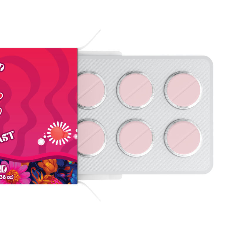 Pink pills in a blister pack with a colorful box on a white background.